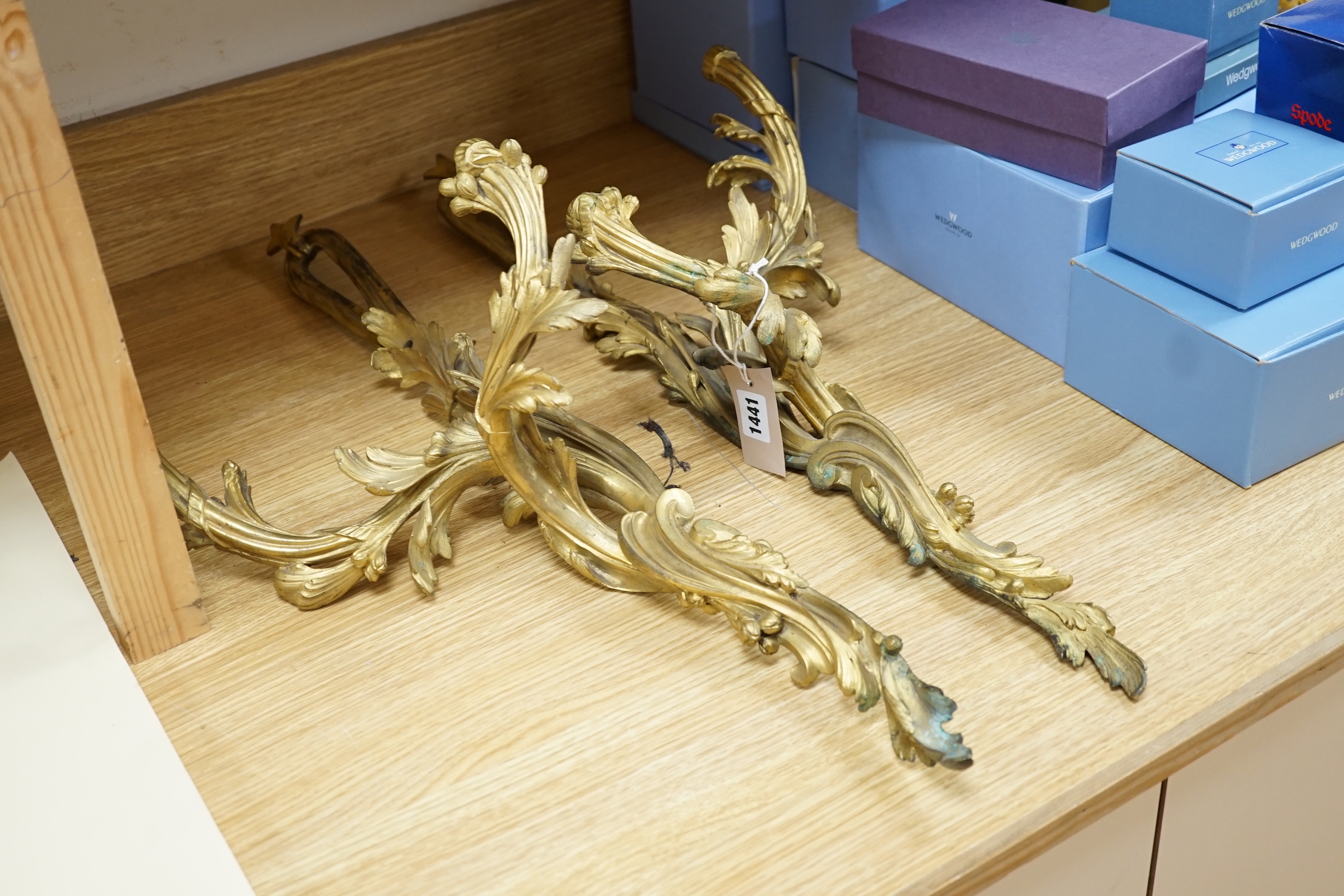 A pair of rococo style ormolu two branch wall lights, 76cm